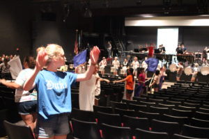 Drum major senior Emmi Dolph leads the band during "One Day More."