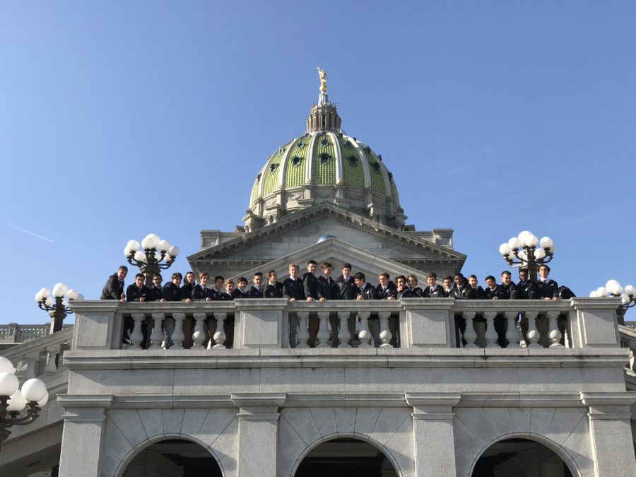 The team stands along the balcony of the Pennsylvania Capitol Building.