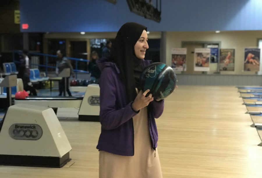 Eyes+on+the+Ball%3A+Junior+Tasniem+Abadalla+holds+the+ball+in+preparation+for+a+throw+down+the+lane.+Abadalla+said+she+joined+due+to+the+fun+and+supportive+nature+of+bowling+club.