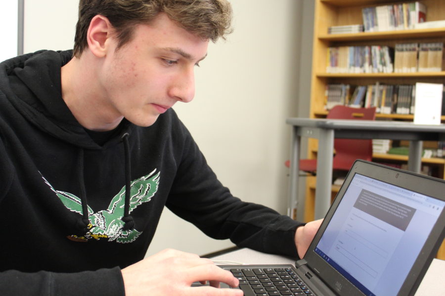 Taking the time: Junior Harry Borislow takes the online student survey regarding new school start times. The survey was administered to all students in grades 5-12 during homeroom on March 14.