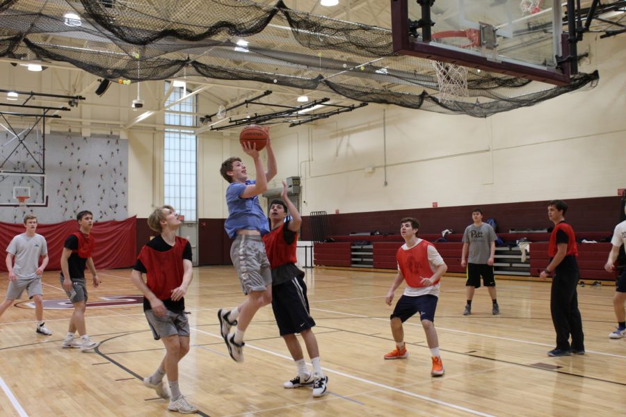 Junior Shane Mahoney goes for a layup during the first round of February Madness. The tournament took place over the week of February 24th and included students from all grades.