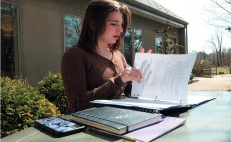 A new status quo: Senior Cate Hashemi flips through the proposal she submitted to school administrators in the fall of 2021. The proposal, originally created by Hashemi  and Conestoga  Class of 2021  alumna Gabi  Valencia, suggested  that the school  implement ideas like  trigger warnings to  help students deal with trauma in English books.