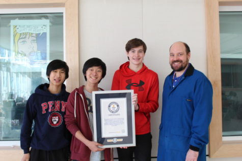 Eggcellent Achievement: Sophomores Matthew Ma, Jeffrey Wang, Charlie Gawthrop and Science Olympiad advisor, Derrick Wood pose for a picture with their Guinness World Record. Last June, the team broke the Guinness World record for the highest protected egg drop. 