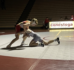 A Conestoga wrestler shoots at his opponent, attempting to take out his legs. The wrestling team defeated Haverford 41-27 on December 15th.