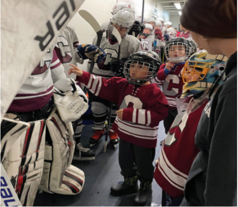 Learning from the pros: Elementary school students line up next to the Conestoga ice hockey teams as they
prepare for their game against Penncrest. The team won 7-2 at Ice Line on Dec. 22.