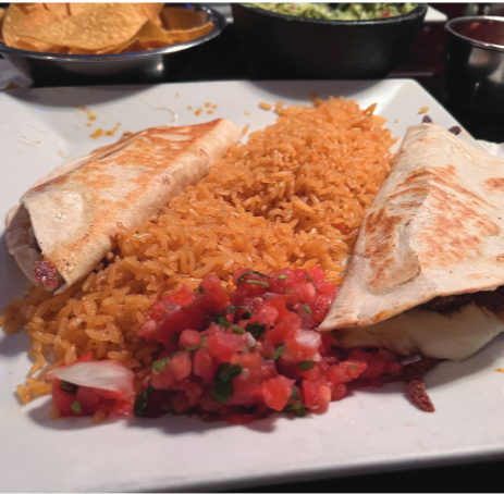 Mexican medley: Beef quesadillas and seasoned rice are placed on
a plate. The restaurant served them alongside fresh  salsa.