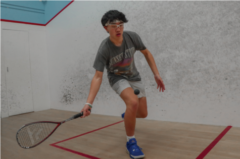 Locked in: Junior George Zhang concentrates in anticipation of hitting the ball in a game of squash. Zhang eventually lost with a record of 2-1 a er a tough battle.