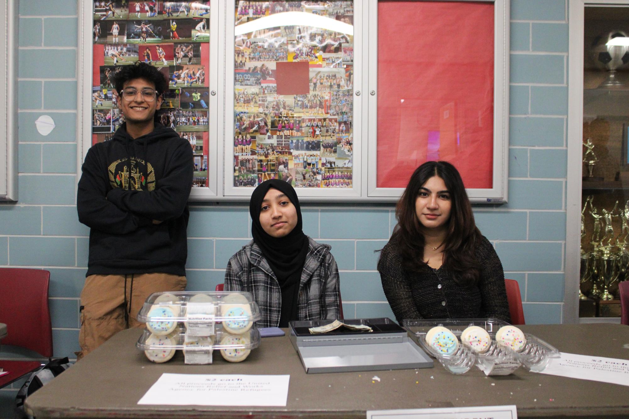 Cookies for a cause: Sophomore Rayan Niaz (left), treasurer of the Muslim Student Association, sells cookies with his fellow club members. The club held the bake sale on Nov. 21 to raise money for Palestinian refugees.