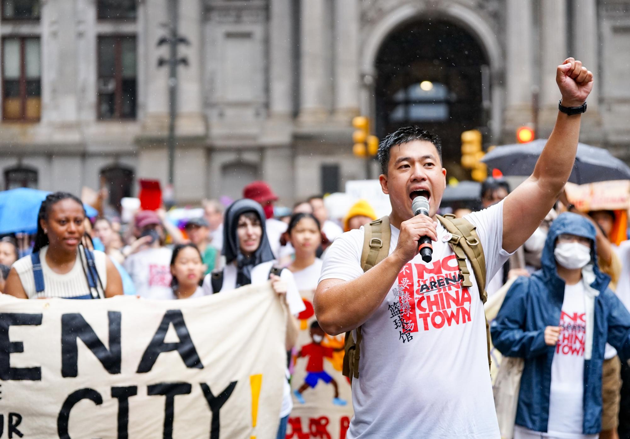 Rallying through the rain: Asian Americans United civic engagement director Wei Chen joins community members marching through the streets of Center City Philadelphia. The Save Chinatown Coalition organized the Sept. 7 rally to protest the proposed 76ers’ arena.