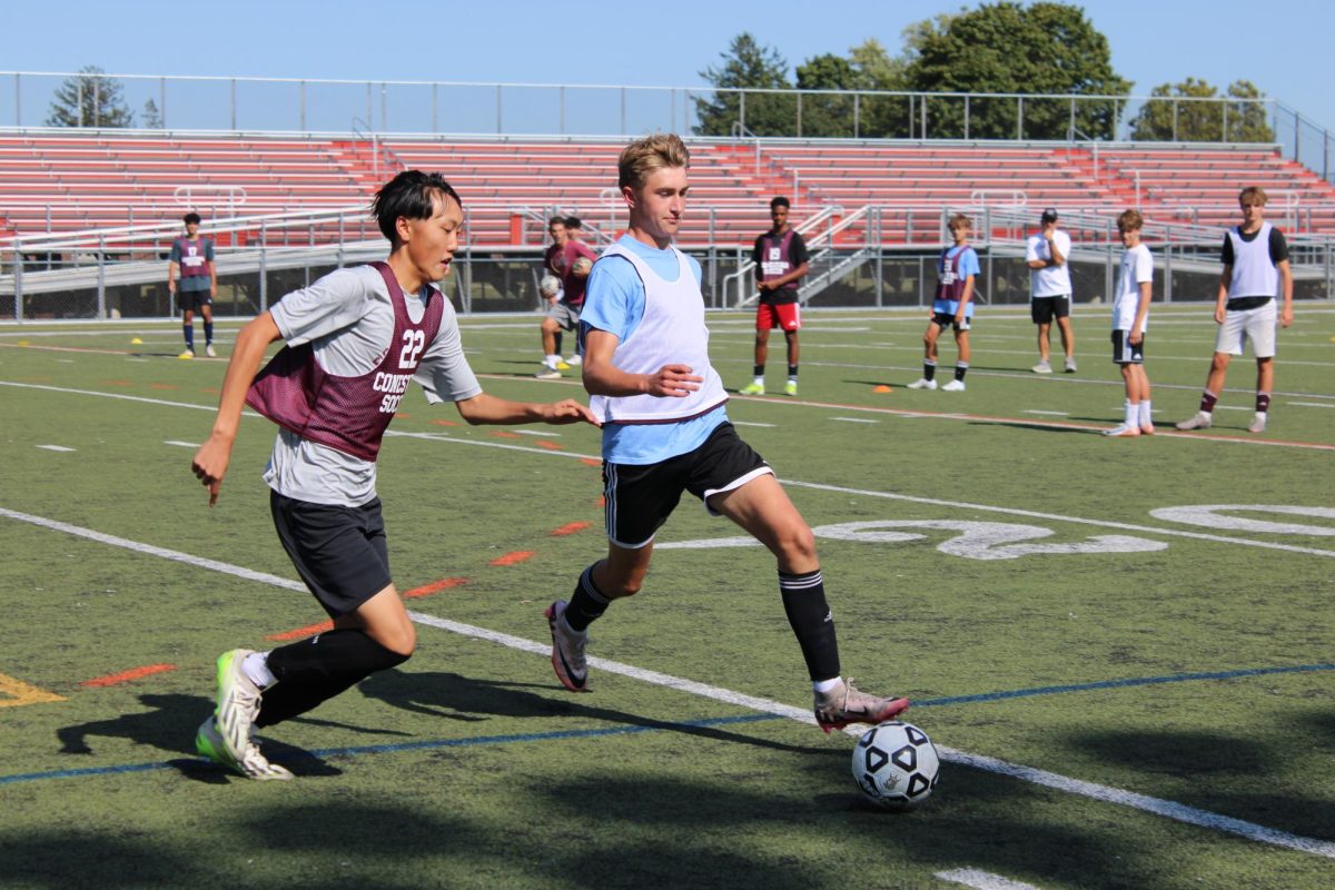 Working hard: Members of the boys’ soccer team work through a drill during a weekday practice on Teamer Field. The team has prioritized working on new formations and tactics throughout the beginning of the season to familiarize the players with one another. It looks forward to continuing its success and their state championship title this season. 