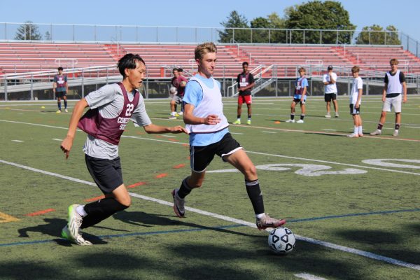 Working hard: Members of the boys’ soccer team work through a drill during a weekday practice on Teamer Field. The team has prioritized working on new formations and tactics throughout the beginning of the season to familiarize the players with one another. It looks forward to continuing its success and their state championship title this season. 