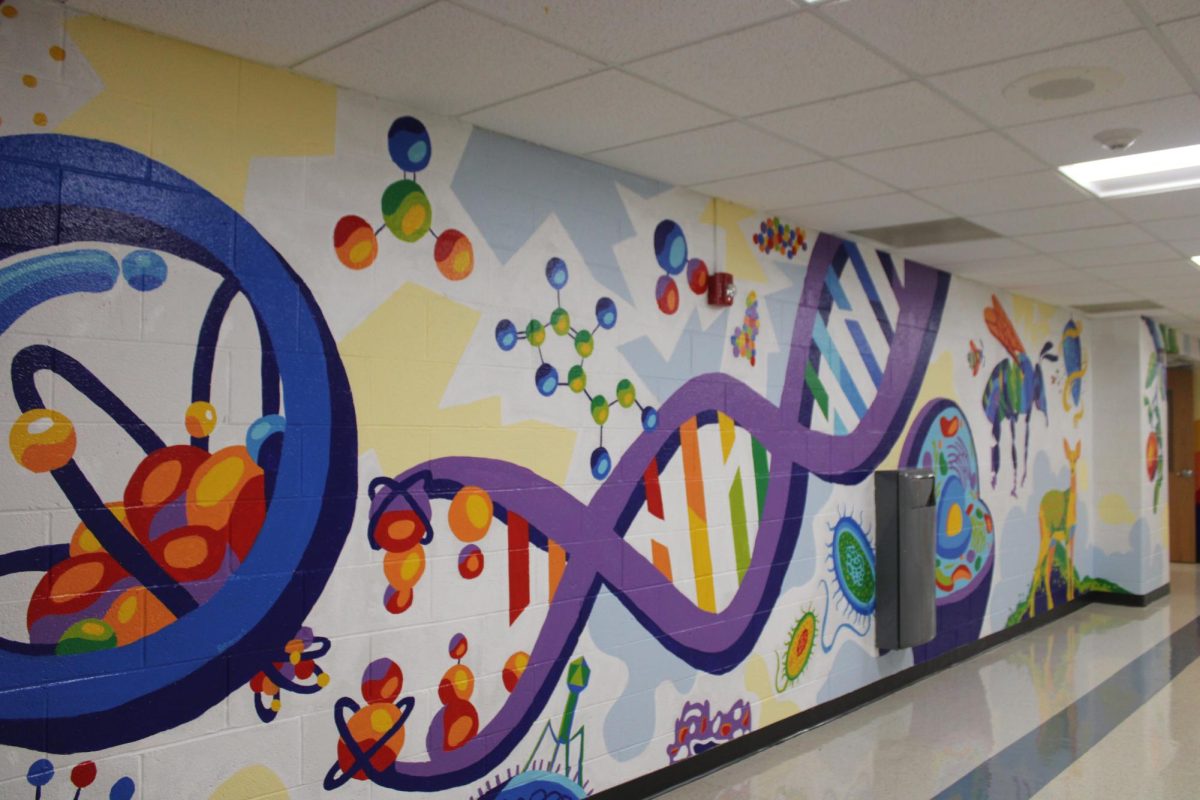 Signs of life: A new mural, located in the downstairs science hallway, is science-themed, depicting DNA, animals and planets. Conestoga National Art Society students created the downstairs mural over the course of the summer.