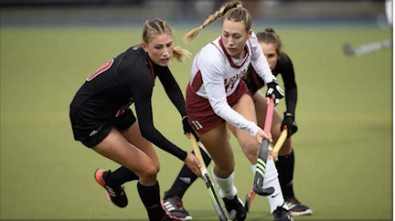 In pursuit: A Louisville field hockey player battles Kiley Allen for the ball.  After playing as a midfielder, Allen returned to Harvard as an assistant coach in 2024. Allen hopes to foster a nurturing environment for her team. 