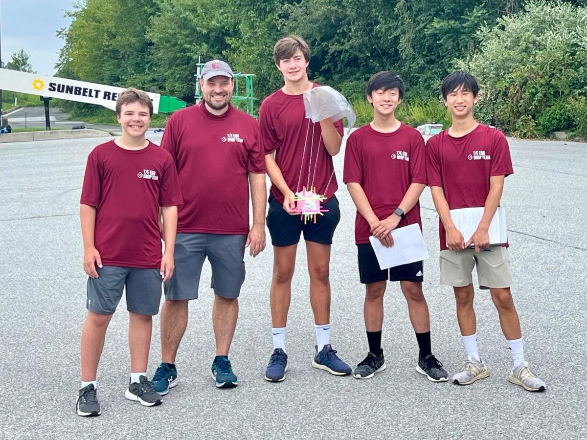 Repeat record: (from left to right) Valley Forge Middle School sixth grader Breckin Shefflerwood; science teacher Dr. Derrick Wood; and seniors Charlie Gawthrop, Jeffrey Wang and Matthew Ma pose with their egg drop device. They started reconstructing the contraption last school year.
