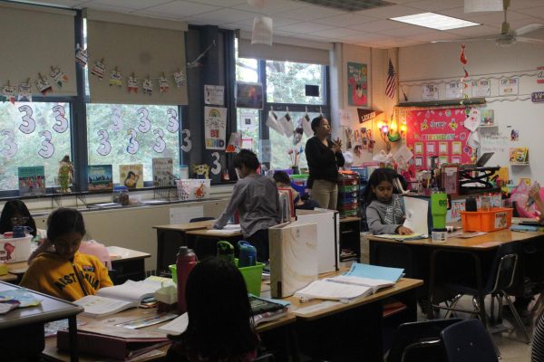 Additional support: Third grade students raise their hands as Valley Forge Elementary School teacher Ashley White prepares to show a math informational video. Last school year, the math benchmark pilot committee began administering potential assessment benchmarks. White’s class will take the pilot third grade math benchmark assessment this year.