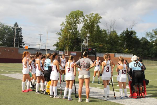 Bringing it home: The players huddle with coach Reagan Marscher during a time-out in the final seconds of their game against Notre Dame. The team ended their regular season undefeated and was named Central League champions. Ultimately, they it hopes to win the PIAA Field Hockey Championships.