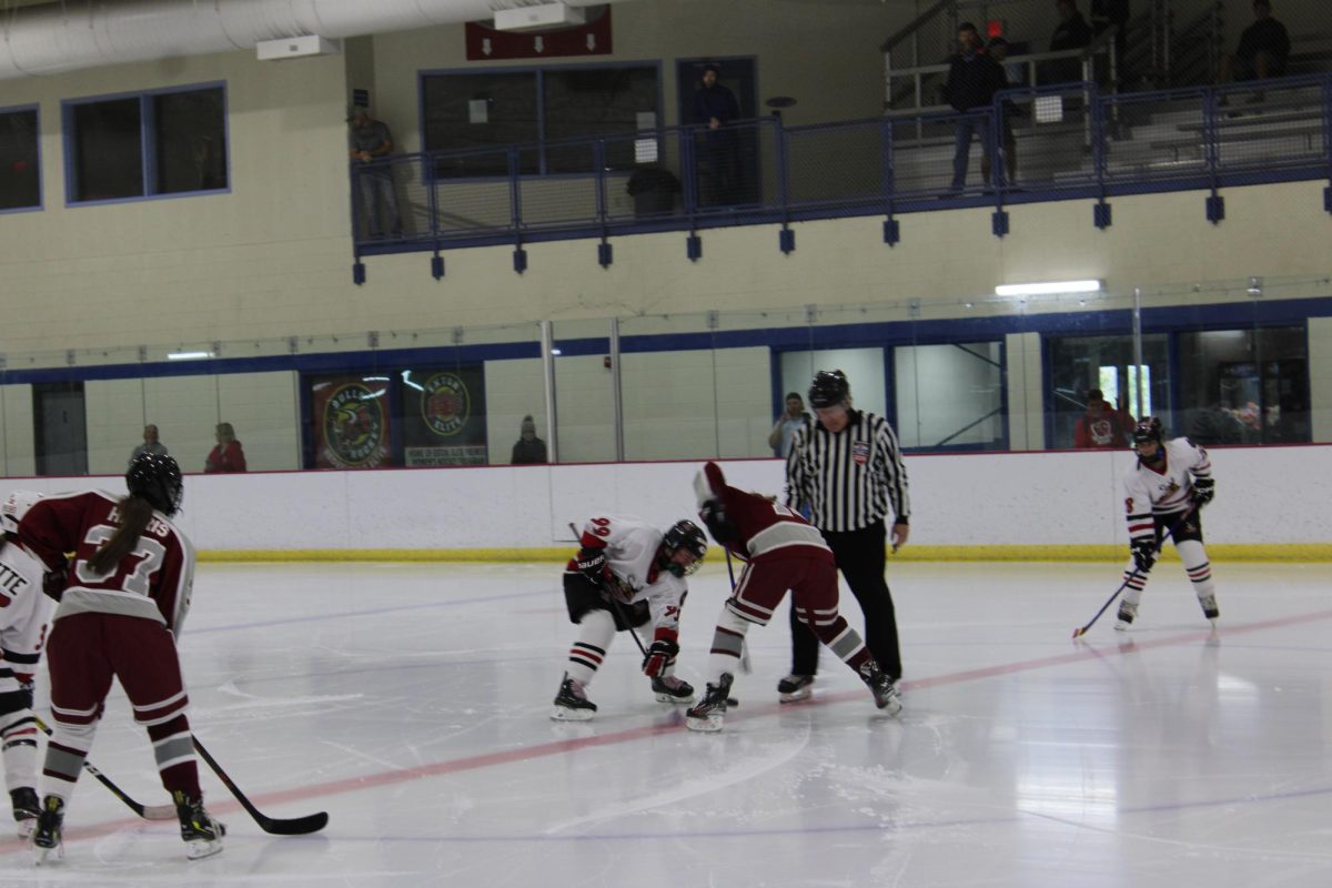 Striking sticks: Captain and senior Lila Valdesalice faces off against a member of the Mighty Moose Ice Hockey team. The team played its fourth JV game against the Mighty Moose on Oct. 12. Conestoga will continue to build its JV program as the season progresses.