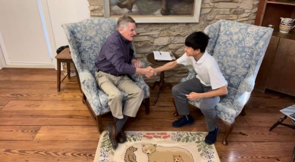 New faces: Microbiologist Tom Bott (left) and sophomore Calvin Kan (right) shake hands following an interview for one of Kan’s short films. Kan expanded his reporting skillset, experimenting with various formats such as documentaries.