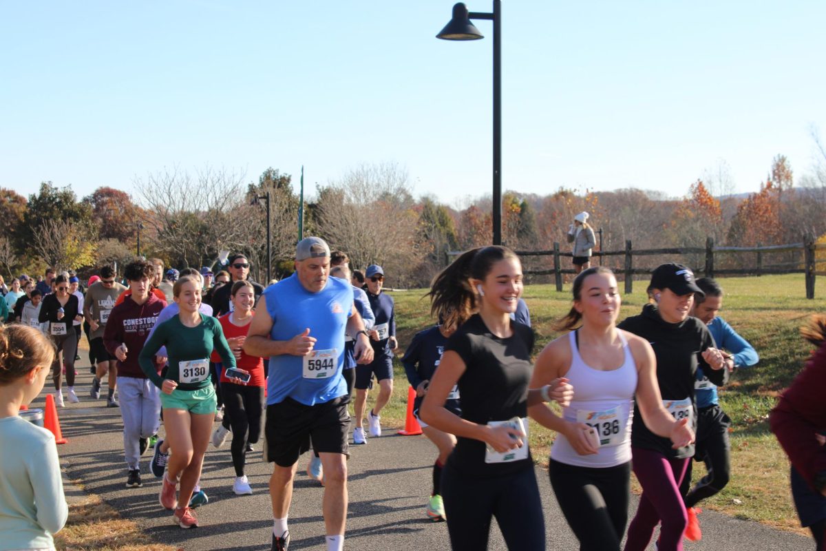 Running for a cause: Participants of ’Stoga’s Case for Smiles 5K run cross the starting line as the event begins. Senior and club founder Ryan Crill organized the run, which took place at Wilson Farm Park on Nov. 17.