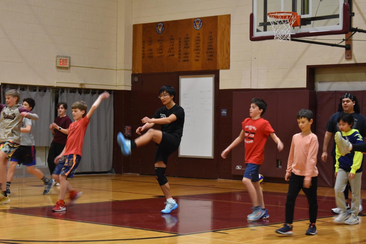 Playing with passion: Junior and boys volleyball co-captain Aiden Lin leads the newly formed boys’ Ka-Hoots team in warm-up. The newly formed boys’ Ka-Hoots program took place six times on Thursdays from 6-8 p.m. in the months of December and January. 
