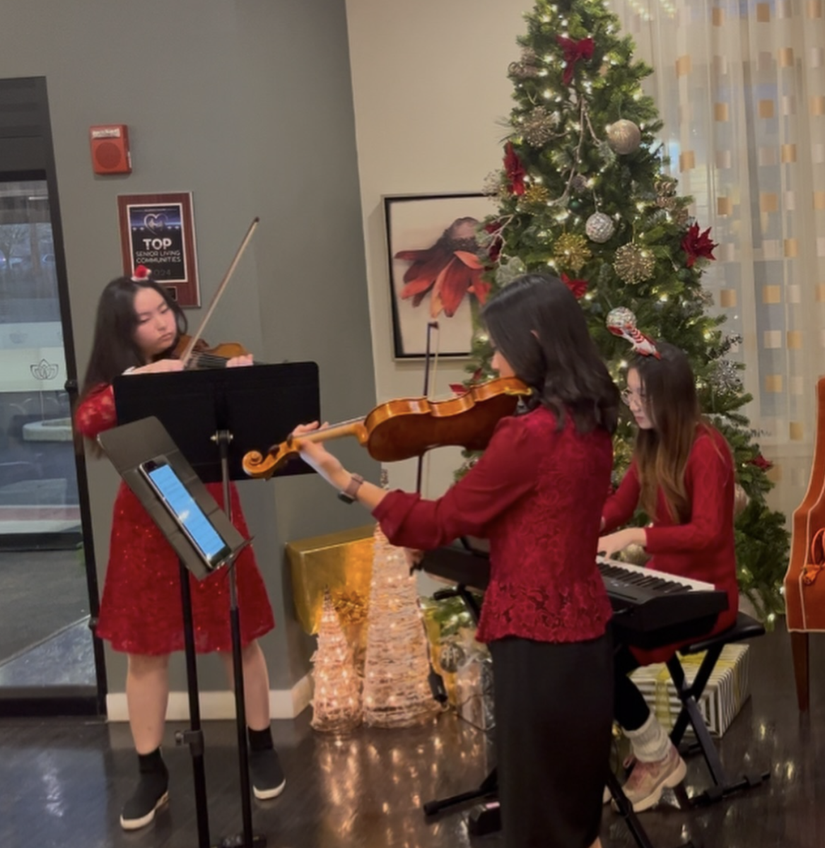 From strings to symphony: Juniors and chamber music group members Hannah Han, Rufei Tang and Sisi Xu perform at assisted living facility Daylesford Crossing during the holiday season. Xu plays the piano, and Han and Tang play the violin.