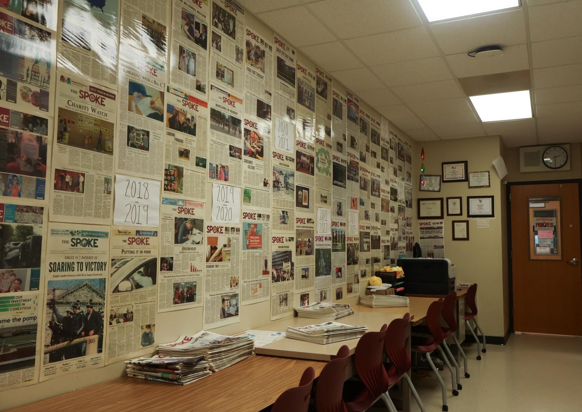 Continuing the legacy: Laminated pages of The Spoke line the walls alongside signs with the school years. The newspaper served as a local news source, beginning under the name Eastfrin Echoes, shifting to The Conestoga Spoke and later choosing The Spoke.