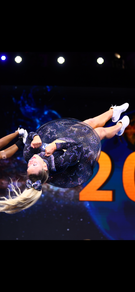 Fearless flips: Sophomore Ellie Grace Crump spins in the middle of a double full twist during her all-girls senior team’s performance at The Cheerleading World 2025 Championship in Orlando, Florida on April 25-28. Crump and her team, New Jersey Spirit Explosion, won silver at the championship. In the future, she hopes to continue cheering through her high school and, potentially, college careers.
