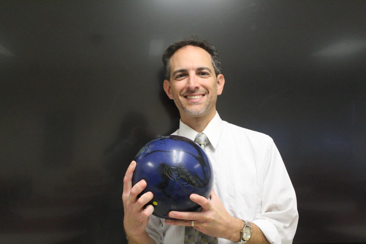 Born bowler: Math teacher and dedicated bowler Vincent Russo holds a bowling ball in his classroom. He has been bowling since he was 5 years old.