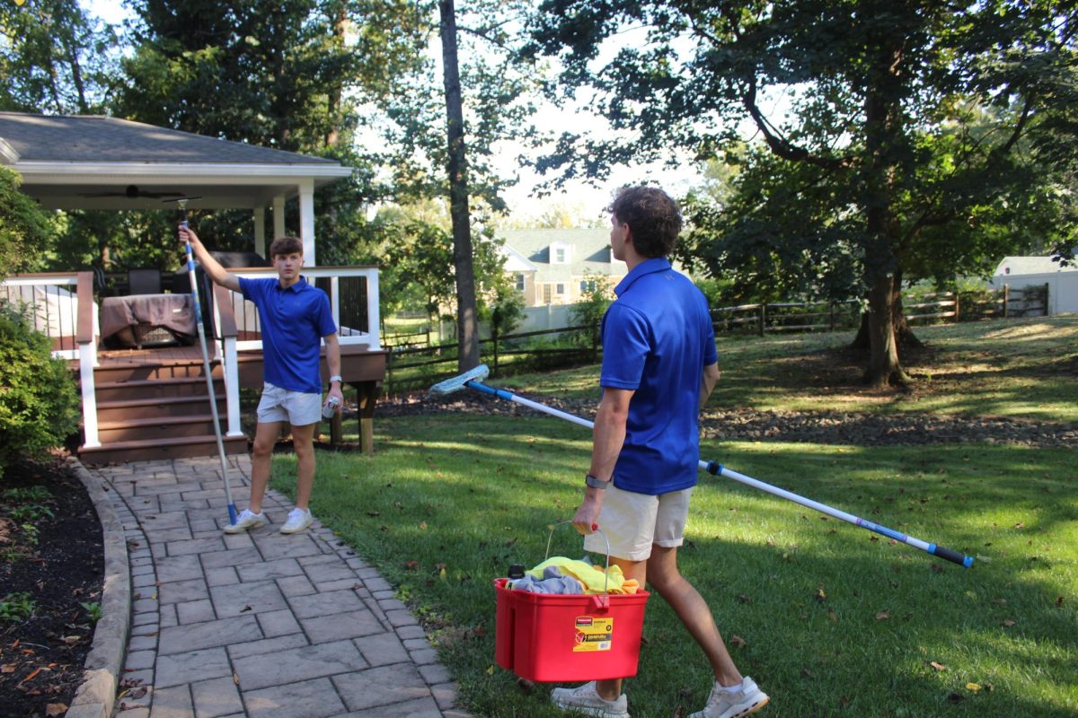Tools of trade: Seniors David Ivory (left) and Will Galef (right) hold equipment for their business, Main Line Window Washing and Yard Services. The two have expanded the organization to offer a plethora of cleaning services to local customers in the surrounding community.