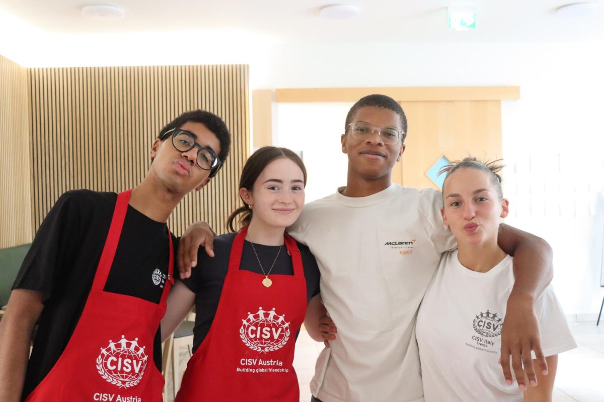 Cultural cooking: Senior Elle Farabaugh (second from left) smiles with her friends from Children’s International Summer Villages (CISV) after cooking lunch together. Farabaugh joined CISV in 2021 and went to Vienna, Austria this summer for three weeks as part of the program.