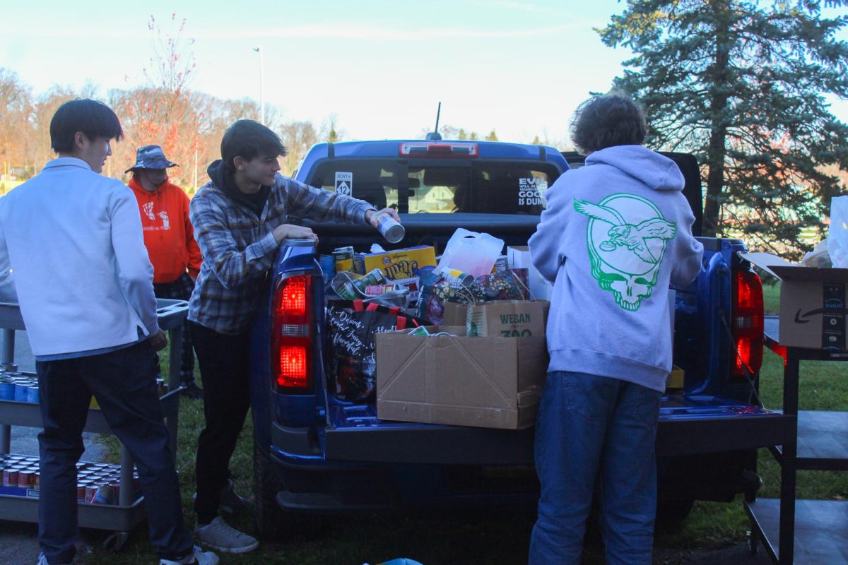 Collecting donations: Members of student council and other students load up trucks full of food donations to address food insecurity. The student council’s annual food drive took place from Nov. 10 to 24 and collected more than 4,000 donated cans.