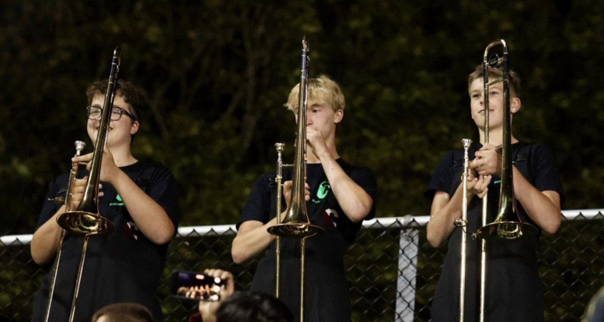 Terrific trombones: Sophomores James Spina (left), Patrick Malone (middle) and freshman Duncan Phipps (right) stand with their instruments at the bleachers on Teamer Field. On Nov. 21, the marching band performed on 6abc news as a part of their “School Spirit Friday” series.