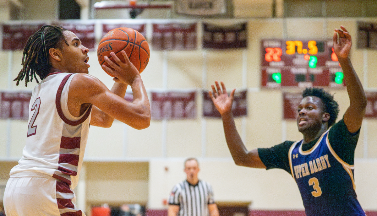Eyes on the prize: Then-junior and point guard Rowan Miller positions himself to shoot the ball during a game against Upper Darby on Dec. 17, 2024. During this summer and preseason, Miller and the returning team members participated in tournaments like the Rome Runs Never Forget Classic. As a co-captain this season, Miller hopes to lead the team to another deep run after a historic district championship win last year.