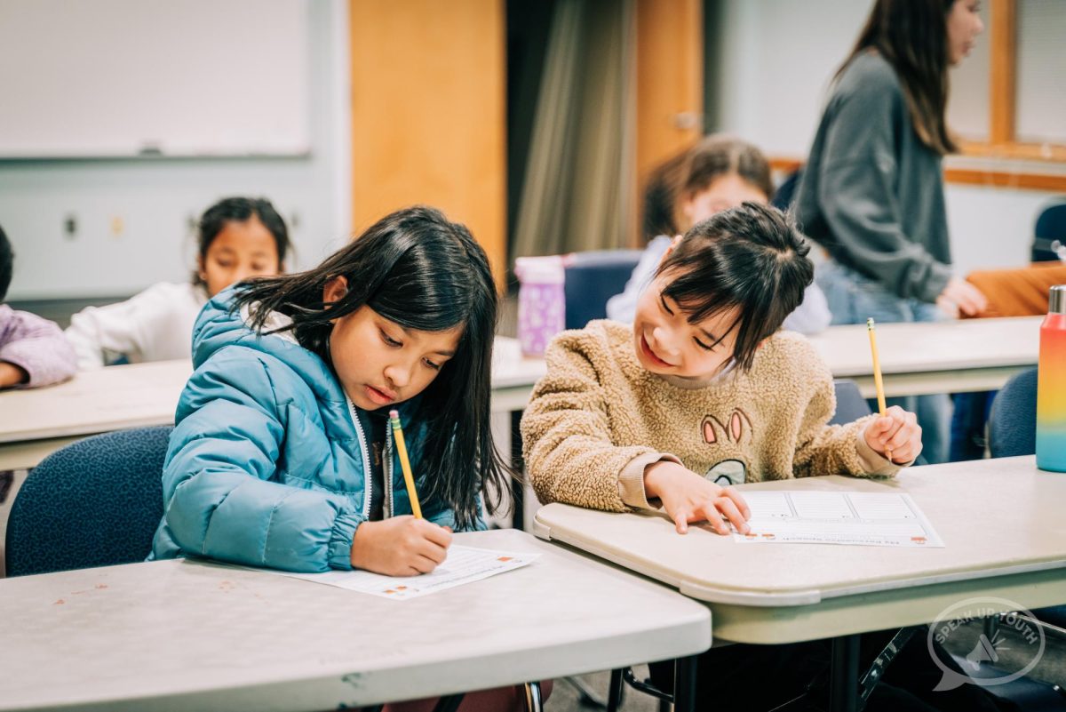 Learning together: Students in Speak Up Youth collaborate in class. Junior Lola Huang started the organization in November.