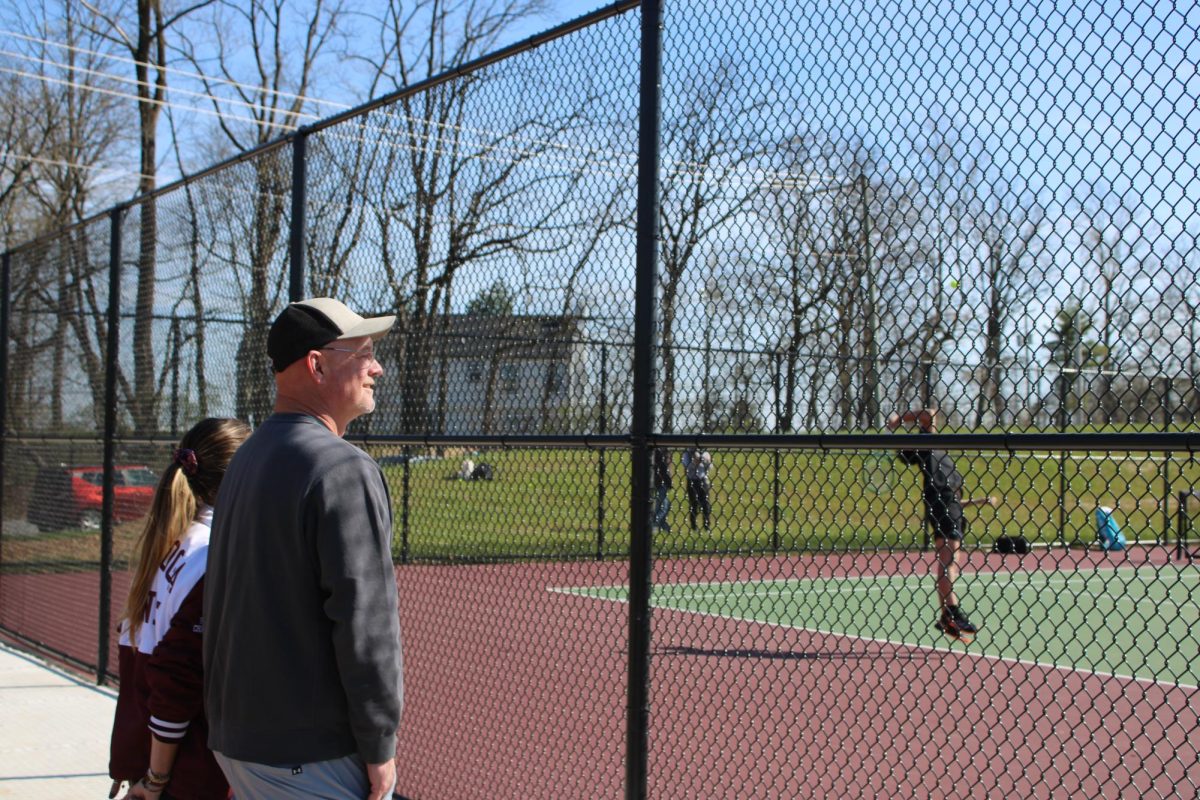 Pechin proud: Athletic director Kevin Pechin watches the Conestoga boys’ tennis team play a home match against Downingtown West on the new courts. The Conestoga team has been very successful, with three PIAA state championship titles under Pechin’s leadership as athletic director. Pechin will continue watching and supporting Conestoga sports after his retirement as “Conestoga’s biggest fan.”