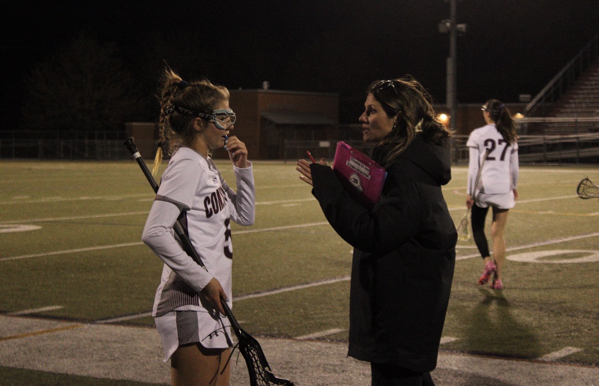 Communicative coaching: On April 4, new girls’ lacrosse coach Jacklyn Collins talks to sophomore Brooke Bickel during a game against Garnet Valley. Under Collins’ leadership, the team recently ranked third in the country this season. This year, the team hopes to continue its success and advance to state championships. 