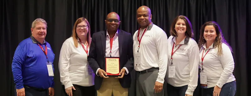 Supporting success: District Human Resources Director Anthony C. Stevenson (middle) holds his President’s Award along with PASPA members. PASPA recognized Stevenson for his contributions to the organization and his community, as well as his work in the field of human resources.