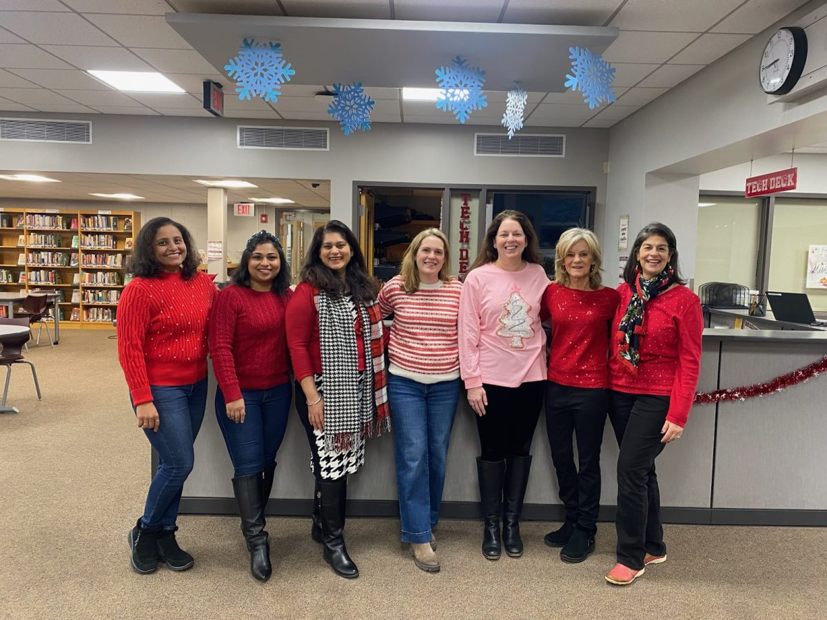 Lasting legacy: Conestoga tech specialist Katrinia Stokes (second from right) stands with her coworkers in the school library for a picture, including library aide Kathy Polites (right). In 1999, Stokes worked as a tech aide at TEMS and then became a high school tech specialist in 2001.