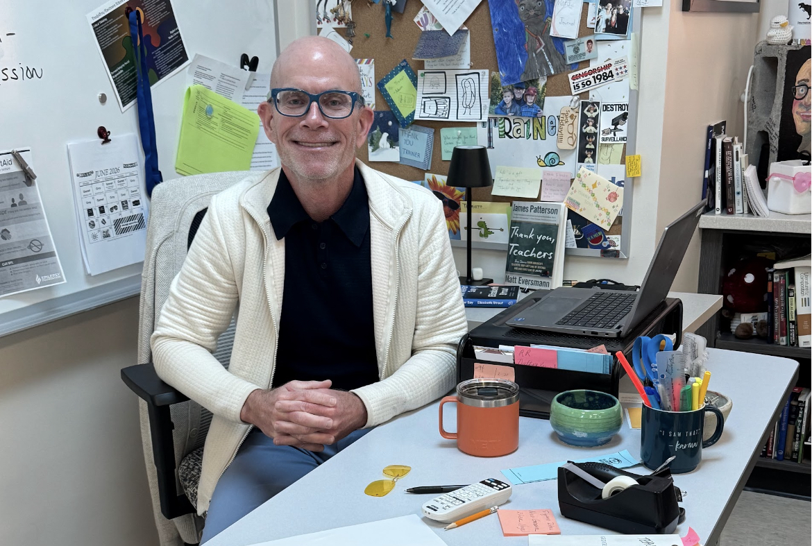 English enthusiast: English teacher Michael Trainer sits at his desk. Trainer minored in English at the University of Scranton and received his master’s at Temple University. He plans to retire this year after 20 years of teaching at Conestoga.